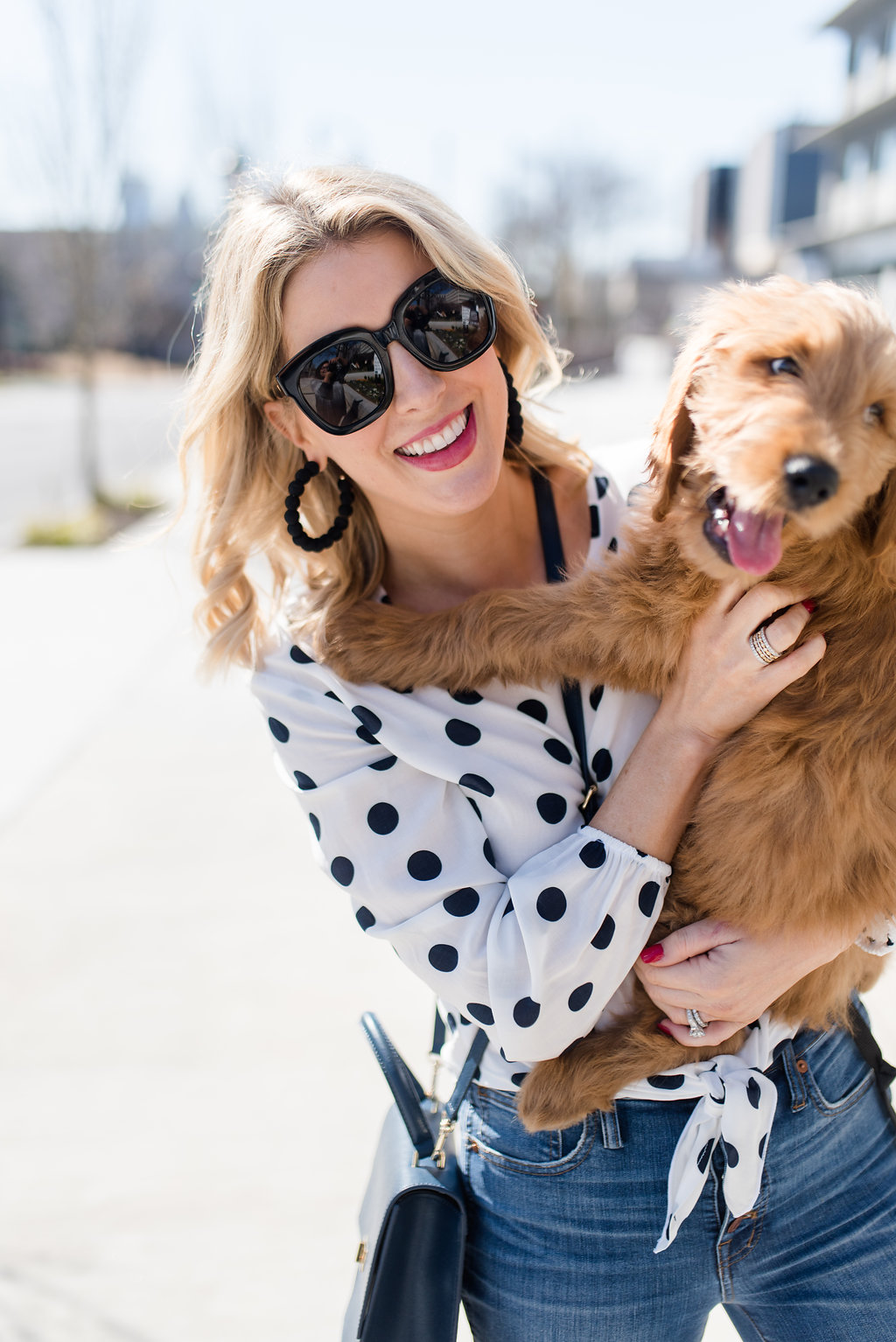 polka dot top and a golden doodle